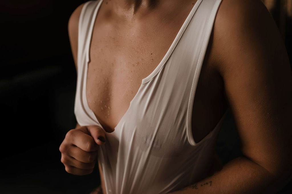 Details of a woman in a wet white shirt